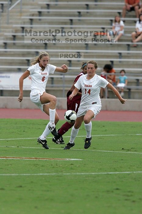 UT freshman Lucy Keith (#6, Midfielder) and UT senior Kasey Moore (#14, Defender) rush to the ball.  The University of Texas women's soccer team won 2-1 against the Iowa State Cyclones Sunday afternoon, October 5, 2008.

Filename: SRM_20081005_12022811.jpg
Aperture: f/5.6
Shutter Speed: 1/1600
Body: Canon EOS-1D Mark II
Lens: Canon EF 300mm f/2.8 L IS