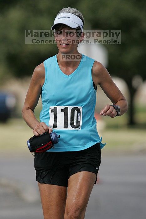 Karen Pearce placed second in her age groun at the Army Dillo half-marathon and 32K race.

Filename: SRM_20080921_1056468.jpg
Aperture: f/4.0
Shutter Speed: 1/2500
Body: Canon EOS-1D Mark II
Lens: Canon EF 300mm f/2.8 L IS