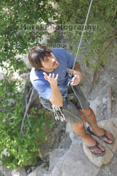 Javier Morales not belaying while I'm at the top of Lick the Window (5.10c), shot (by Andrew Dreher) from the top of Ack! (5.11b, but using the crack for the start instead) that I top roped up with my camera on my back.  It was another long day of rock climbing at Seismic Wall on Austin's Barton Creek Greenbelt, Sunday, April 5, 2009.

Filename: SRM_20090405_14425271.jpg
Aperture: f/3.2
Shutter Speed: 1/500
Body: Canon EOS-1D Mark II
Lens: Canon EF 80-200mm f/2.8 L