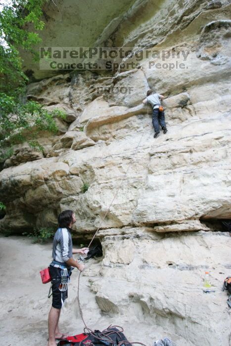 Andrew Dreher lead climbing Magster (5.10a) with Javier Morales belaying.  It was another long day of rock climbing at Seismic Wall on Austin's Barton Creek Greenbelt, Saturday, April 11, 2009.

Filename: SRM_20090411_15301081.JPG
Aperture: f/4.0
Shutter Speed: 1/250
Body: Canon EOS-1D Mark II
Lens: Canon EF 16-35mm f/2.8 L