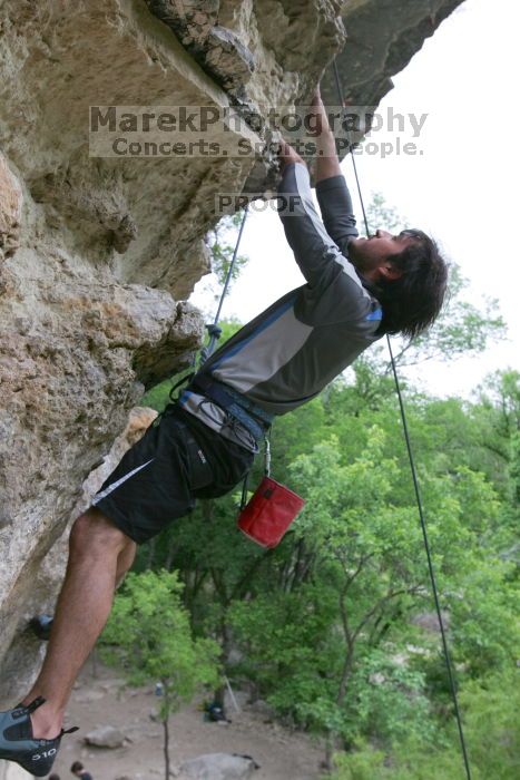 Javier Morales top rope climbing Diving for Rocks (5.10d), photographed from  the third bolt of Magster (5.10a).  It was another long day of rock climbing at Seismic Wall on Austin's Barton Creek Greenbelt, Saturday, April 11, 2009.

Filename: SRM_20090411_16493166.JPG
Aperture: f/5.6
Shutter Speed: 1/320
Body: Canon EOS-1D Mark II
Lens: Canon EF 16-35mm f/2.8 L