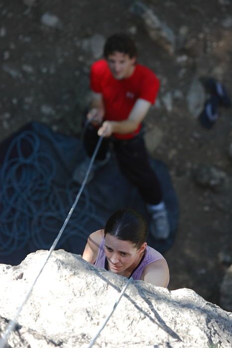 Beth Marek top rope climbing Roo Dog (5.8) with Andrew Dreher belaying, taken from the anchors of the route.  It was Beth's third time outside, and another long day of rock climbing at Seismic Wall on Austin's Barton Creek Greenbelt, Monday, May 25, 2009.

Filename: SRM_20090525_09405284.JPG
Aperture: f/4.0
Shutter Speed: 1/500
Body: Canon EOS-1D Mark II
Lens: Canon EF 80-200mm f/2.8 L