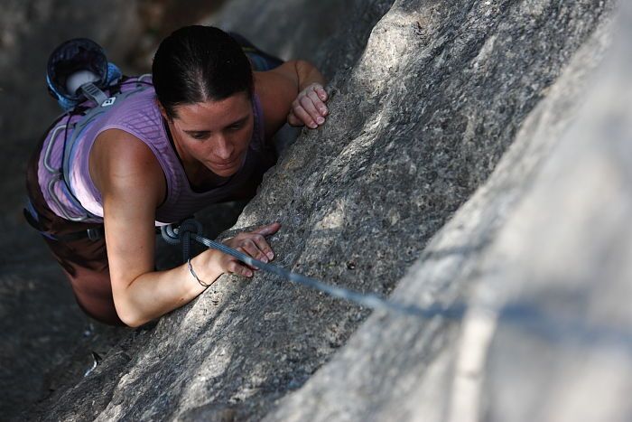 Beth Marek top rope climbing Hollywood (5.7), taken from the anchors of the route.  It was Beth's third time outside, and another long day of rock climbing at Seismic Wall on Austin's Barton Creek Greenbelt, Monday, May 25, 2009.

Filename: SRM_20090525_10392342.JPG
Aperture: f/4.0
Shutter Speed: 1/1000
Body: Canon EOS-1D Mark II
Lens: Canon EF 80-200mm f/2.8 L