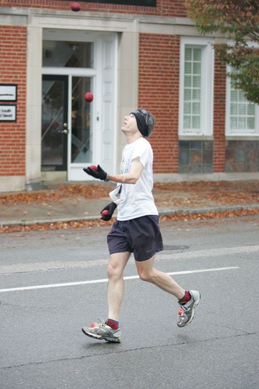 Barry Goldmeier, bib #16608 (8K) and  #5587 (marathon) juggling and running the 8K at the Richmond SunTrust Marathon and McDonald's Half Marathon, on Saturday, November 14, 2009.

Filename: SRM_20091114_07573261.JPG
Aperture: f/2.8
Shutter Speed: 1/320
Body: Canon EOS-1D Mark II
Lens: Canon EF 80-200mm f/2.8 L