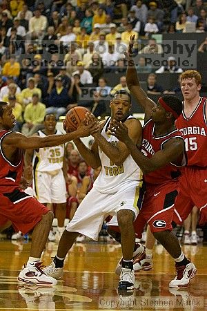 B.J. Elder fends off two UGA defenders.  Men's Basketball Georgia Tech beat UGA 87-49.

Filename: crw_5970_std.jpg
Aperture: f/2.8
Shutter Speed: 1/640
Body: Canon EOS DIGITAL REBEL
Lens: Canon EF 80-200mm f/2.8 L
