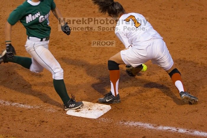 The toss to first baseman Crystal Saenz, #7, is a little too late as the Mean Green runner is safe..  The Lady Longhorns beat the University of North Texas 5-0 in the first game of the double header Wednesday night.

Filename: SRM_20060308_212551_0.jpg
Aperture: f/2.8
Shutter Speed: 1/800
Body: Canon EOS 20D
Lens: Canon EF 80-200mm f/2.8 L
