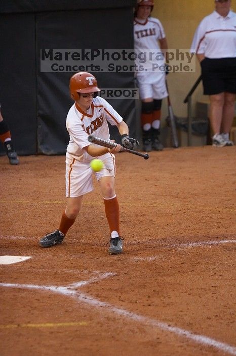 #9, Rachael Cook, bunts against the Mean Green.  The Lady Longhorns beat the University of North Texas 5-0 in the first game of the double header Wednesday night.

Filename: SRM_20060308_211731_8.jpg
Aperture: f/2.8
Shutter Speed: 1/800
Body: Canon EOS 20D
Lens: Canon EF 80-200mm f/2.8 L