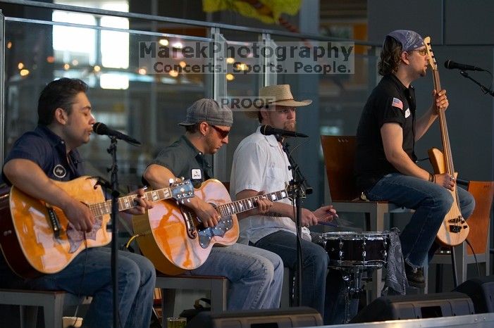 The Gene Pool, performing at the Austin airport.  Geno Stroia II on vocals/guitar, Jorge Castillo on vocals/guitar, Travis Woodard on drums and Steven Ray Will on vocals/bass guitar.

Filename: SRM_20060518_155758_9.jpg
Aperture: f/2.8
Shutter Speed: 1/250
Body: Canon EOS 20D
Lens: Canon EF 80-200mm f/2.8 L