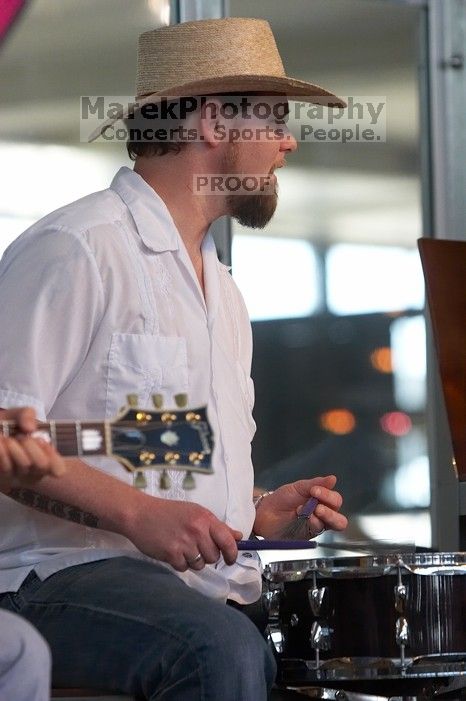 The Gene Pool, performing at the Austin airport.  Geno Stroia II on vocals/guitar, Jorge Castillo on vocals/guitar, Travis Woodard on drums and Steven Ray Will on vocals/bass guitar.

Filename: SRM_20060518_154942_9.jpg
Aperture: f/4.5
Shutter Speed: 1/200
Body: Canon EOS 20D
Lens: Canon EF 80-200mm f/2.8 L