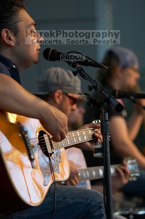 The Gene Pool, performing at the Austin airport.  Geno Stroia II on vocals/guitar, Jorge Castillo on vocals/guitar, Travis Woodard on drums and Steven Ray Will on vocals/bass guitar.

Filename: SRM_20060518_155446_0.jpg
Aperture: f/2.8
Shutter Speed: 1/250
Body: Canon EOS 20D
Lens: Canon EF 80-200mm f/2.8 L