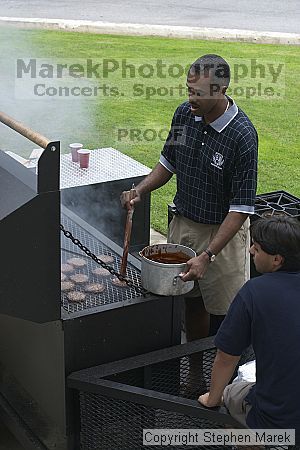 Coach Paul Hewitt and Jimmy Mitchell grill hamburgers at AXO Thursday night.  AXO was the winning sorority for the basketball attendance competition.

Filename: crw_0050_std.jpg
Aperture: f/6.3
Shutter Speed: 1/80
Body: Canon EOS DIGITAL REBEL
Lens: Canon EF 50mm f/1.8 II