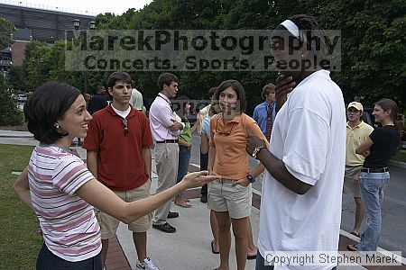 Suzannah Gill, Casey Taylor and Clarence Moore have a conversation after Coach Hewitt's cookout at AXO.  AXO was the winning sorority for the basketball attendance competition.

Filename: crw_0095_std.jpg
Aperture: f/6.3
Shutter Speed: 1/80
Body: Canon EOS DIGITAL REBEL
Lens: Sigma 15-30mm f/3.5-4.5 EX Aspherical DG DF