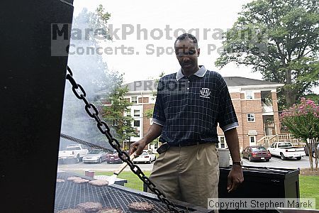 Coach Paul Hewitt grills hamburgers at AXO Thursday night.  AXO was the winning sorority for the basketball attendance competition.

Filename: crw_0045_std.jpg
Aperture: f/6.3
Shutter Speed: 1/80
Body: Canon EOS DIGITAL REBEL
Lens: Sigma 15-30mm f/3.5-4.5 EX Aspherical DG DF