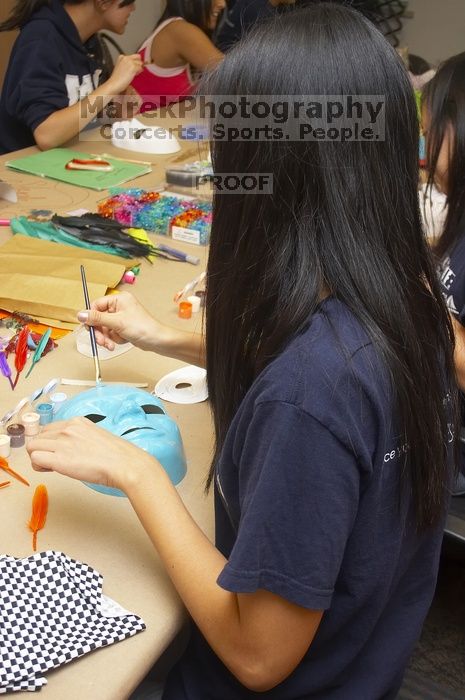 Jenny Hsu decorates a mask at a domestic violence expressive arts workshop for survivors and friends of survivors of domestic and relationship violence.

Filename: SRM_20061023_1730060.jpg
Aperture: f/5.6
Shutter Speed: 1/100
Body: Canon EOS 20D
Lens: Canon EF-S 18-55mm f/3.5-5.6