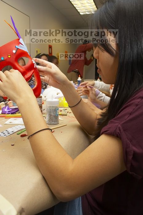 Emily Ng finishing up her mask at a domestic violence expressive arts workshop for survivors and friends of survivors of domestic and relationship violence.

Filename: SRM_20061023_1806005.jpg
Aperture: f/5.6
Shutter Speed: 1/100
Body: Canon EOS 20D
Lens: Canon EF-S 18-55mm f/3.5-5.6