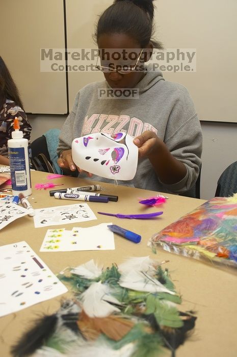 Vimbai Madzura decorates a mask to express herself at a domestic violence expressive arts workshop for survivors and friends of survivors of domestic and relationship violence.

Filename: SRM_20061023_1809043.jpg
Aperture: f/5.6
Shutter Speed: 1/100
Body: Canon EOS 20D
Lens: Canon EF-S 18-55mm f/3.5-5.6