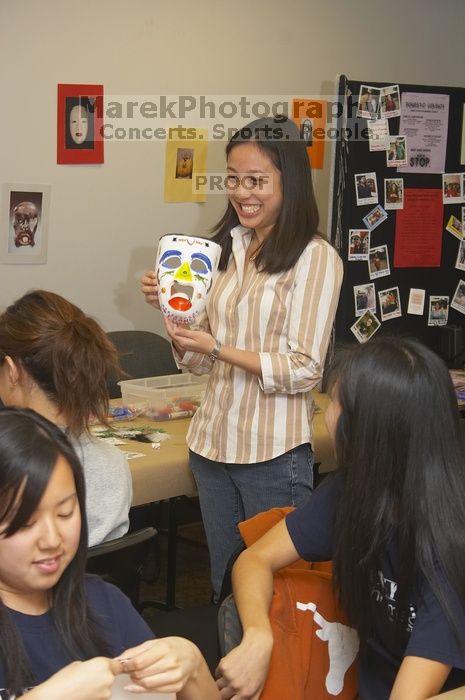 Rita Saynhalath displays her mask at a domestic violence expressive arts workshop for survivors and friends of survivors of domestic and relationship violence.
Filename: SRM_20061023_1821245.jpg
Aperture: f/5.6
Shutter Speed: 1/100
Body: Canon EOS 20D
Lens: Canon EF-S 18-55mm f/3.5-5.6