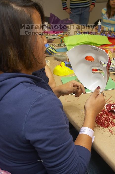 Steph Nhem discusses her mask at a domestic violence expressive arts workshop for survivors and friends of survivors of domestic and relationship violence.

Filename: SRM_20061023_1823442.jpg
Aperture: f/5.6
Shutter Speed: 1/100
Body: Canon EOS 20D
Lens: Canon EF-S 18-55mm f/3.5-5.6