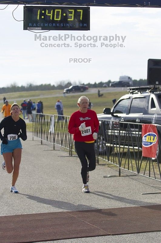 Stefani Day, 1:40:25, and James Hill, 1:40:34, finishing at the Decker Challenge 20K 2006 road race.

Filename: SRM_20061203_0944248.jpg
Aperture: f/4.0
Shutter Speed: 1/1250
Body: Canon EOS-1D Mark II
Lens: Canon EF 80-200mm f/2.8 L