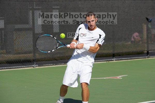 Texas' Dimitar Kutrovsky defeated Tech's Jose Muguruza 6-2 and 6-3.  The University of Texas (UT) men's tennis team defeated Georgia Tech (GT) Saturday, February 24, 2007..

Filename: SRM_20070224_1438481.jpg
Aperture: f/4.0
Shutter Speed: 1/8000
Body: Canon EOS-1D Mark II
Lens: Canon EF 80-200mm f/2.8 L