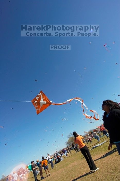 Madhav Tadikonda, class of 1997, and Anjali Patel, class of 1999, fly a UT kite at the 79th annual Zilker Park Kite Festival, Sunday, March 4, 2007.

Filename: SRM_20070304_1538284.jpg
Aperture: f/11.0
Shutter Speed: 1/250
Body: Canon EOS-1D Mark II
Lens: Sigma 15-30mm f/3.5-4.5 EX Aspherical DG DF