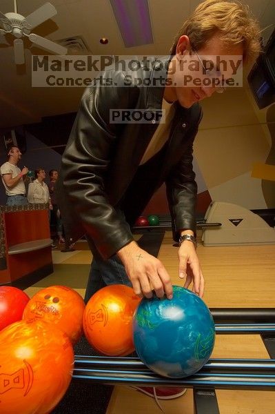 Blake Lindell reaches for a bowling ball. Alpha Xi Delta held a sock hop themed date night at the Austin 300 bowling alley, Thursday night, March 29, 2007.
Filename: SRM_20070329_2022022.jpg
Aperture: f/8.0
Shutter Speed: 1/200
Body: Canon EOS-1D Mark II
Lens: Sigma 15-30mm f/3.5-4.5 EX Aspherical DG DF