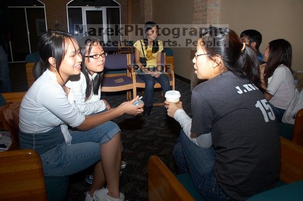 Thu Mai, Thu Vo, and Julia Kuo talking.  The Asian Business Students Association (ABSA) hosted a chocolate fondue Friday, January 26, 2007 before heading off to a movie premier.

Filename: SRM_20070126_1621186.jpg
Aperture: f/5.6
Shutter Speed: 1/125
Body: Canon EOS 20D
Lens: Canon EF-S 18-55mm f/3.5-5.6