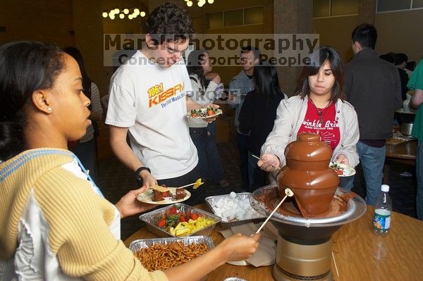 D'Andra Thomas-Jackson, Ian McCoy, and Christina Canales enjoy the chocolate fondue.  The Asian Business Students Association (ABSA) hosted a chocolate fondue Friday, January 26, 2007 before heading off to a movie premier.

Filename: SRM_20070126_1622507.jpg
Aperture: f/5.0
Shutter Speed: 1/125
Body: Canon EOS 20D
Lens: Canon EF-S 18-55mm f/3.5-5.6