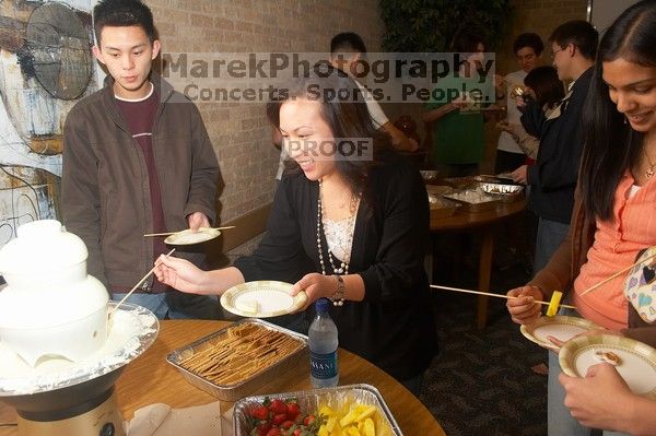Lance Shyr, left, and Michelle Hoang enjoying the white chocolate.  The Asian Business Students Association (ABSA) hosted a chocolate fondue Friday, January 26, 2007 before heading off to a movie premier.

Filename: SRM_20070126_1624560.jpg
Aperture: f/5.0
Shutter Speed: 1/125
Body: Canon EOS 20D
Lens: Canon EF-S 18-55mm f/3.5-5.6