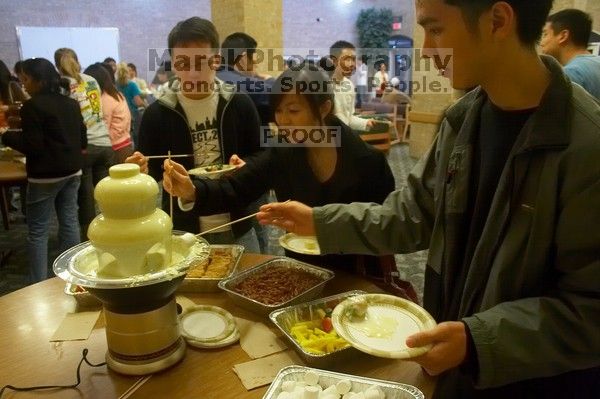 Andrew Wu, Mimi Nguyen, and Quan Ma.  The Asian Business Students Association (ABSA) hosted a chocolate fondue Friday, January 26, 2007 before heading off to a movie premier.

Filename: SRM_20070126_1632240.jpg
Aperture: f/4.5
Shutter Speed: 1/40
Body: Canon EOS 20D
Lens: Canon EF-S 18-55mm f/3.5-5.6