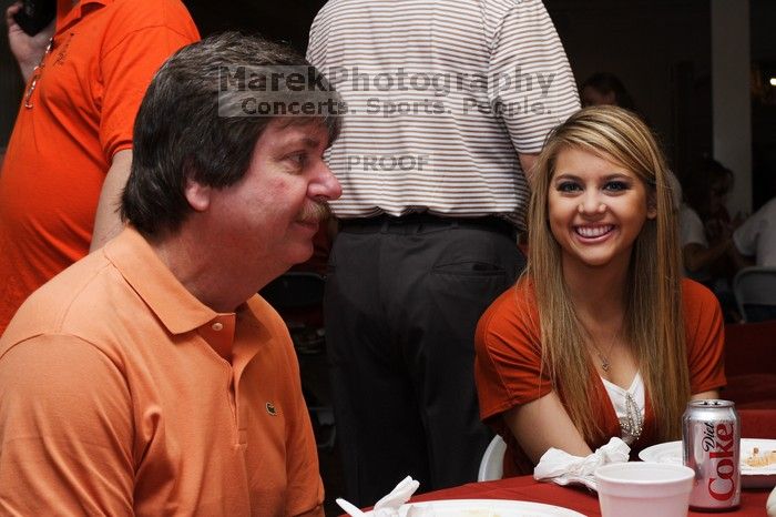 Tahnae Tarkenton eats lunch with her parents.  Kappa Kappa Gamma (KKG) hosted a parents' weekend barbecue before the UT vs Nebraska football game on Saturday, October 27, 2007 at their sorority house.

Filename: SRM_20071027_1131506.jpg
Aperture: f/8.0
Shutter Speed: 1/125
Body: Canon EOS-1D Mark II
Lens: Canon EF 50mm f/1.8 II