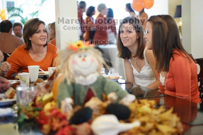 Hannah Koeijmans (in white), Madeline Koeijmans (in red), Grace Koeijmans (in brown and orange) and their parents.  Kappa Kappa Gamma (KKG) hosted a parents' weekend barbecue before the UT vs Nebraska football game on Saturday, October 27, 2007 at their so

Filename: SRM_20071027_1148266.jpg
Aperture: f/1.8
Shutter Speed: 1/40
Body: Canon EOS-1D Mark II
Lens: Canon EF 50mm f/1.8 II