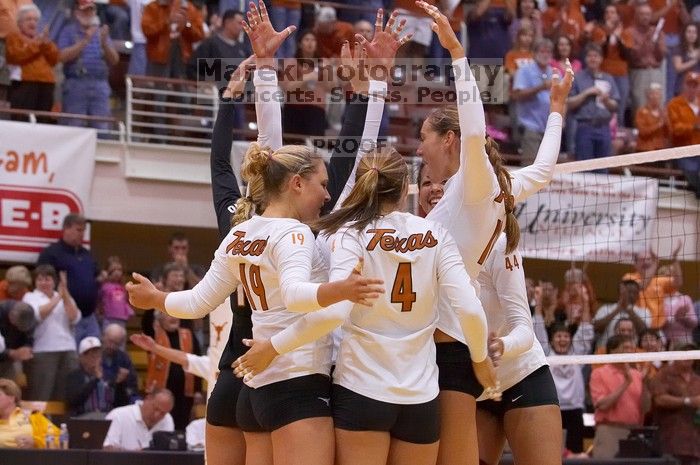 UT sophomore Heather Kisner (#19, DS), UT senior Michelle Moriarty (#4, S), and UT sophomore Ashley Engle (#10, S/RS) celebrate a point with their teammates.  The Longhorns defeated the Huskers 3-0 on Wednesday night, October 24, 2007 at Gregory Gym.

Filename: SRM_20071024_1837501.jpg
Aperture: f/4.5
Shutter Speed: 1/400
Body: Canon EOS-1D Mark II
Lens: Canon EF 80-200mm f/2.8 L