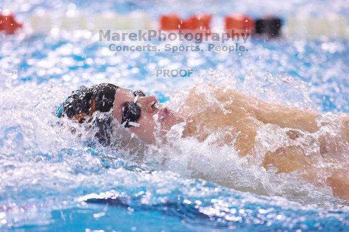 UT sophomore Alan Maher competed in the second heat of the 100 yard backstroke with a time of 51.88.  The University of Texas Longhorns defeated The University of Georgia Bulldogs 157-135 on Saturday, January 12, 2008.

Filename: SRM_20080112_1120520.jpg
Aperture: f/2.8
Shutter Speed: 1/400
Body: Canon EOS-1D Mark II
Lens: Canon EF 300mm f/2.8 L IS
