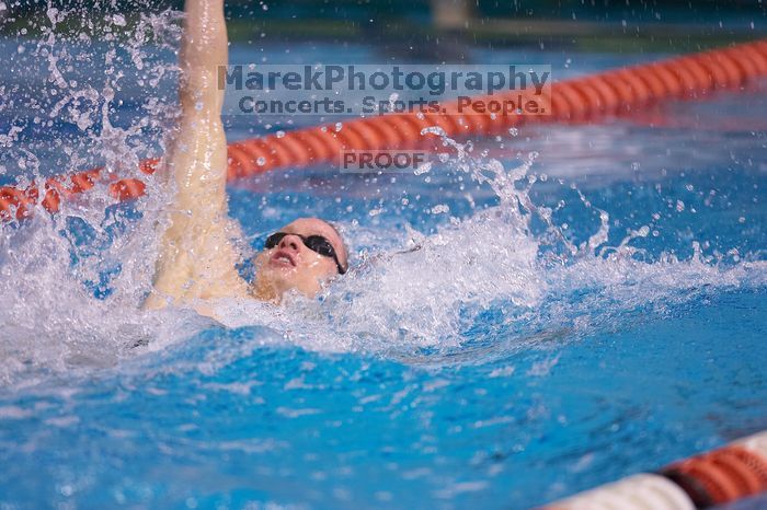 UT senior Matthew McGinnis took first in the 200 yard backstroke with a time of 1:47.37.  The University of Texas Longhorns defeated The University of Georgia Bulldogs 157-135 on Saturday, January 12, 2008.

Filename: SRM_20080112_1159080.jpg
Aperture: f/2.8
Shutter Speed: 1/400
Body: Canon EOS-1D Mark II
Lens: Canon EF 300mm f/2.8 L IS