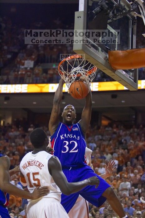 KU senior Darnell Jackson (#32, Forward) dunks over UT freshman Alexis Wangmene (#15, F/C) and UT junior Connor Atchley (#32, F/C). The University of Texas (UT) Longhorns defeated the University of Kansas Jayhawks 72-69 in Austin, Texas on Monday, February 11, 2008.
Filename: SRM_20080211_2046089.jpg
Aperture: f/2.8
Shutter Speed: 1/640
Body: Canon EOS-1D Mark II
Lens: Canon EF 80-200mm f/2.8 L