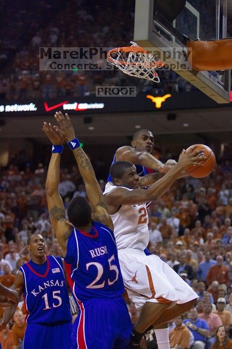 UT sophomore Justin Mason (#24, G) attempts a shot over KU junior Brandon Rush (#25, Guard) and KU junior Mario Chalmers (#15, Guard).  The University of Texas (UT) Longhorns defeated the University of Kansas Jayhawks 72-69 in Austin, Texas on Monday, February 11, 2008.

Filename: SRM_20080211_2128263.jpg
Aperture: f/2.8
Shutter Speed: 1/640
Body: Canon EOS-1D Mark II
Lens: Canon EF 80-200mm f/2.8 L