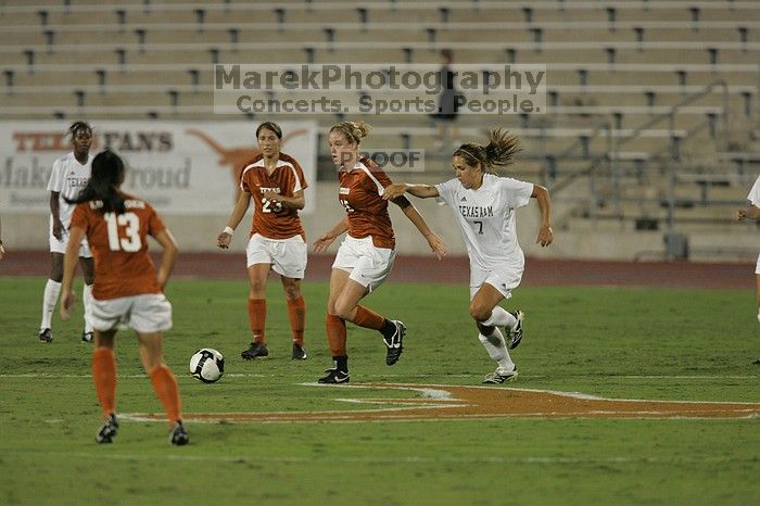 UT freshman Kylie Doniak (#15, Midfielder) has the ball as UT senior Courtney Gaines (#23, Midfielder) and UT freshman Amanda Lisberger (#13, Midfielder) watch.  The University of Texas women's soccer team tied 0-0 against the Texas A&M Aggies Friday night, September 27, 2008.

Filename: SRM_20080926_1937002.jpg
Aperture: f/4.0
Shutter Speed: 1/500
Body: Canon EOS-1D Mark II
Lens: Canon EF 300mm f/2.8 L IS