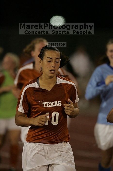 UT senior Stephanie Logterman (#10, Defender) running back to the team benches before the second half. The University of Texas women's soccer team tied 0-0 against the Texas A&M Aggies Friday night, September 27, 2008.
Filename: SRM_20080926_2000443.jpg
Aperture: f/2.8
Shutter Speed: 1/500
Body: Canon EOS-1D Mark II
Lens: Canon EF 300mm f/2.8 L IS