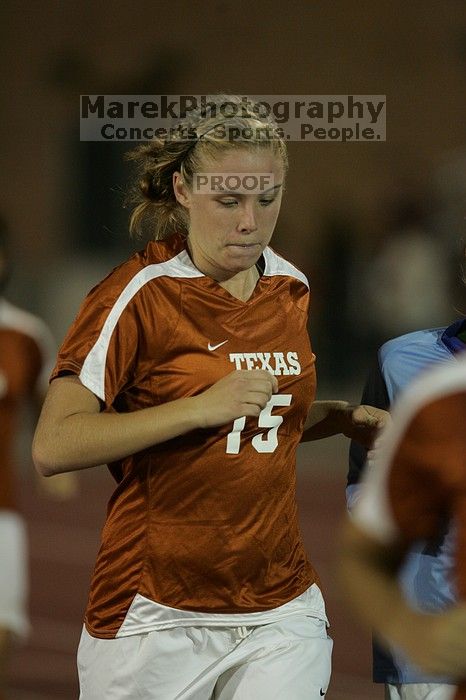 UT freshman Kylie Doniak (#15, Midfielder) running back to the team benches before the second half.  The University of Texas women's soccer team tied 0-0 against the Texas A&M Aggies Friday night, September 27, 2008.

Filename: SRM_20080926_2000466.jpg
Aperture: f/2.8
Shutter Speed: 1/500
Body: Canon EOS-1D Mark II
Lens: Canon EF 300mm f/2.8 L IS