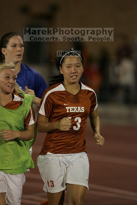 UT freshman Amanda Lisberger (#13, Midfielder) running back to the team benches before the second half.  The University of Texas women's soccer team tied 0-0 against the Texas A&M Aggies Friday night, September 27, 2008.

Filename: SRM_20080926_2000467.jpg
Aperture: f/2.8
Shutter Speed: 1/500
Body: Canon EOS-1D Mark II
Lens: Canon EF 300mm f/2.8 L IS