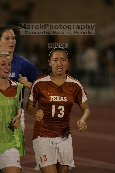 UT freshman Amanda Lisberger (#13, Midfielder) running back to the team benches before the second half. The University of Texas women's soccer team tied 0-0 against the Texas A&M Aggies Friday night, September 27, 2008.
Filename: SRM_20080926_2000468.jpg
Aperture: f/2.8
Shutter Speed: 1/500
Body: Canon EOS-1D Mark II
Lens: Canon EF 300mm f/2.8 L IS