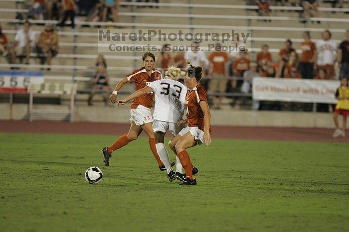 UT senior Kasey Moore (#14, Defender) tackles the ball as UT senior Courtney Gaines (#23, Midfielder) watches. The University of Texas women's soccer team tied 0-0 against the Texas A&M Aggies Friday night, September 27, 2008.
Filename: SRM_20080926_2012065.jpg
Aperture: f/2.8
Shutter Speed: 1/500
Body: Canon EOS-1D Mark II
Lens: Canon EF 300mm f/2.8 L IS