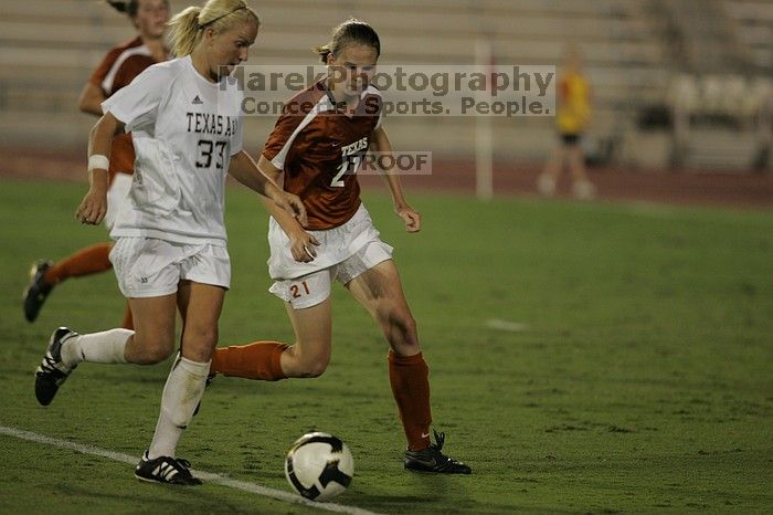 UT junior Emily Anderson (#21, Forward) plays defense on A&M #33.  The University of Texas women's soccer team tied 0-0 against the Texas A&M Aggies Friday night, September 27, 2008.

Filename: SRM_20080926_2027449.jpg
Aperture: f/2.8
Shutter Speed: 1/640
Body: Canon EOS-1D Mark II
Lens: Canon EF 300mm f/2.8 L IS