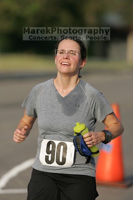 Beth Marek won first place in her age division at the Army Dillo half-marathon and 32K race.
Filename: SRM_20080921_0841429.jpg
Aperture: f/4.0
Shutter Speed: 1/2000
Body: Canon EOS-1D Mark II
Lens: Canon EF 300mm f/2.8 L IS