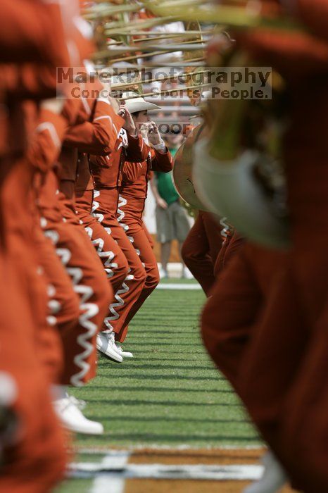 The UT marching band takes the field before the Arkansas football game.  The University of Texas football team defeated the Arkansas Razorbacks with a score of 52-10 in Austin, TX on Saturday, September 27, 2008.

Filename: SRM_20080927_14205441.jpg
Aperture: f/5.6
Shutter Speed: 1/1250
Body: Canon EOS-1D Mark II
Lens: Canon EF 300mm f/2.8 L IS