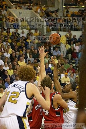 B.J. Elder goes up for the ball as Luke Schenscher looks on.  Men's Basketball Georgia Tech beat UGA 87-49.

Filename: crw_5980_std.jpg
Aperture: f/2.8
Shutter Speed: 1/640
Body: Canon EOS DIGITAL REBEL
Lens: Canon EF 80-200mm f/2.8 L