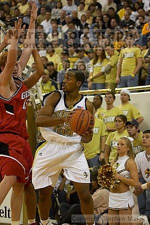 Zam Fredrick II fends off two UGA defenders.  Men's Basketball Georgia Tech beat UGA 87-49.

Filename: crw_5964_std.jpg
Aperture: f/2.8
Shutter Speed: 1/640
Body: Canon EOS DIGITAL REBEL
Lens: Canon EF 80-200mm f/2.8 L