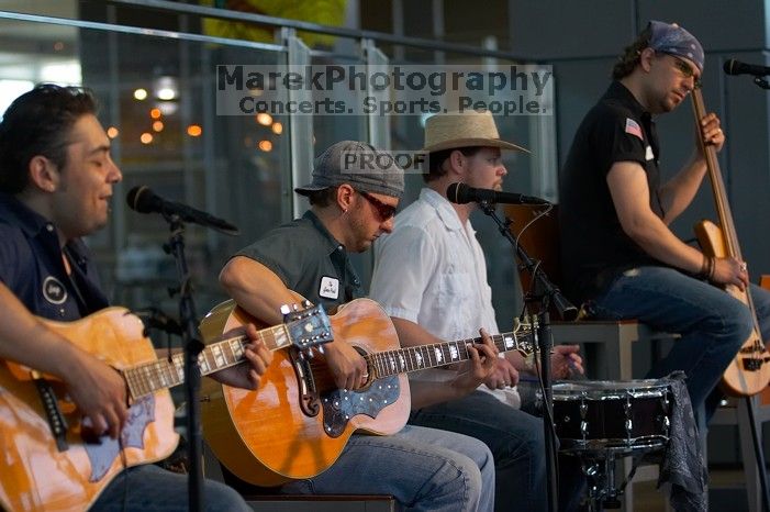 The Gene Pool, performing at the Austin airport.  Geno Stroia II on vocals/guitar, Jorge Castillo on vocals/guitar, Travis Woodard on drums and Steven Ray Will on vocals/bass guitar.

Filename: SRM_20060518_155544_0.jpg
Aperture: f/2.8
Shutter Speed: 1/250
Body: Canon EOS 20D
Lens: Canon EF 80-200mm f/2.8 L